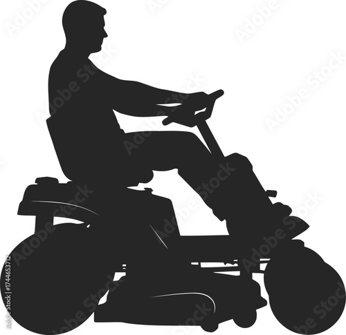 Silhouette of a person mowing a lawn with grass cutting equipment