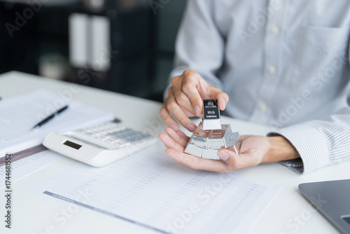 Silver bar Trading business man hand offering silver Investment financial report Trading Pure silver precious metals investment  on the stock exchange Rising prices.