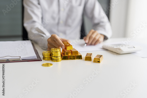 Gold bar Trading business people hand offering gold Investment in gold mining company or Trading gold on the stock exchange Rising prices.