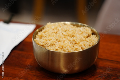 Bowl of freshly cooked brown rice on a wooden table