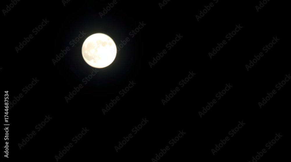 Obraz premium High contrast, low-key lighting with a blurred bokeh effect of the moon, featuring sharp subject focus, a soft background, deep shadows, and a dramatic effect