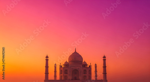 Majestic Taj Mahal bathed in vibrant sunset hues of pink and orange, an iconic symbol of love and architectural wonder.