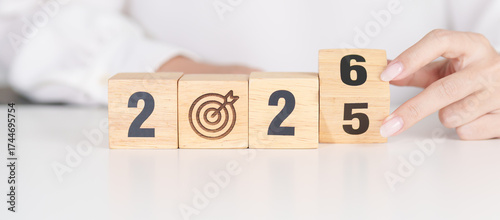 2025 year change to 2026 year block with dartboard icon. Goal, Target, Resolution, strategy, plan, Action, mission, motivation, and New Year start concepts