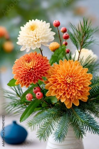 Orange and white chrysanthemums with pine and berries decoration