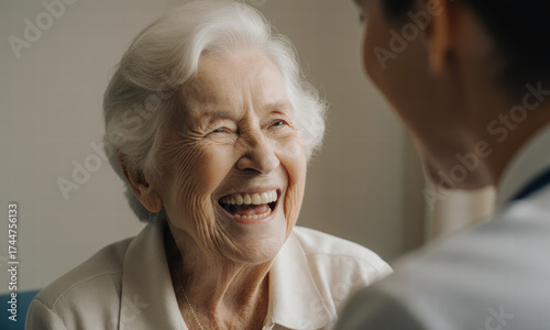 Joyful senior woman laughing heartily with a companion
