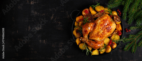 Baked chicken or turkey. Roasted chicken with potatoes and Christmas decoration.  Table setting. Top view, above