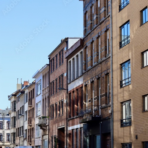 Old townhouses lining a city street with traditional brick facades and architecture. Antwerp, Belgium