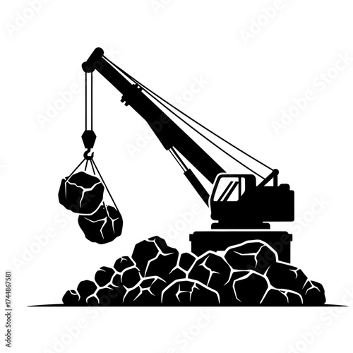 Silhouette of a construction crane lifting heavy rocks.