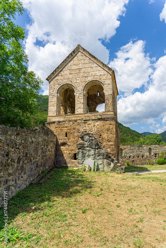 Foto Two-story bell tower in the church yard with arched windows