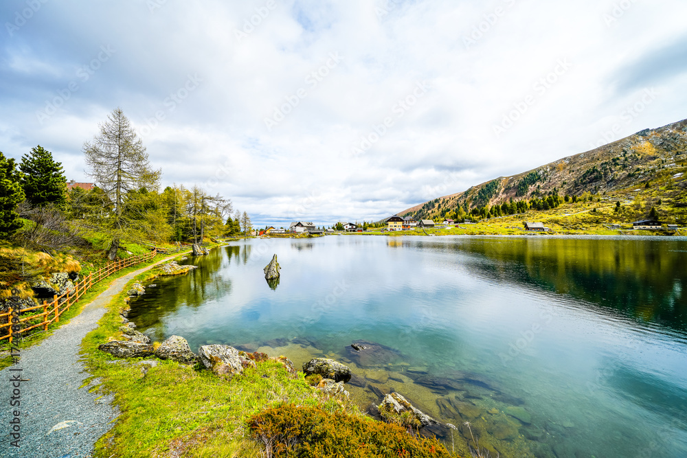 Fototapeta premium View of Lake Falkert in the Gurktal Alps and the surrounding landscape. Nature at a mountain lake in Carinthia. High mountain lake in Austria. 