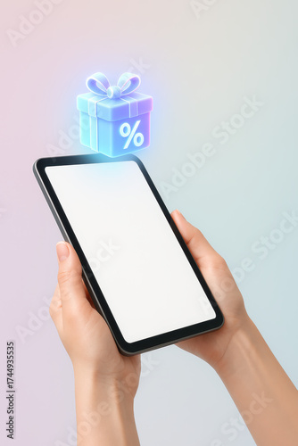 Digital Discount: A person holds a tablet showcasing an illuminated gift box with a percentage symbol, symbolizing special offers and promotions.