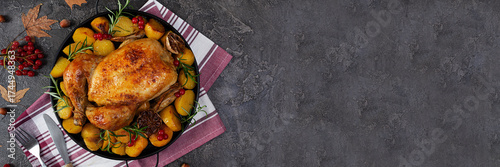 Roasted chicken with potatoes. Autumn decoration Thanksgiving day. Baked whole chicken.