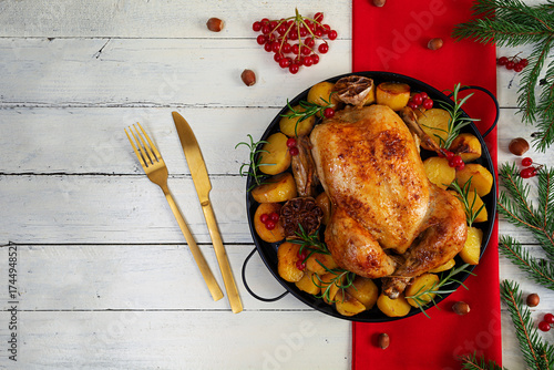 Baked whole chicken. Roasted chicken with potatoes. Winter decoration Christmas chicken