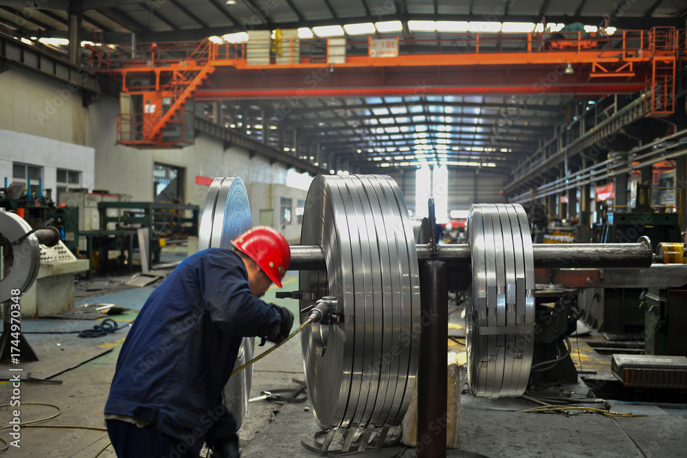 Fototapeta premium Workers on the production line of the strip steel coil factory are working