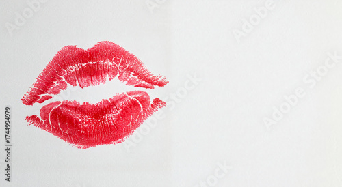 Red lipstick kiss mark on white paper with copy space