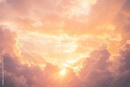 Sunburst through pink and orange clouds at sunset light