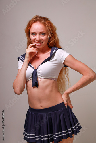 Beautiful sexy red-haired girl in a sailor costume