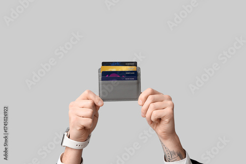 Young man holding wallet wi...