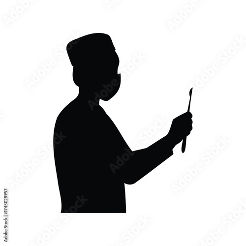 Silhouette of medical professional wearing cap and mask, holding surgical instrument