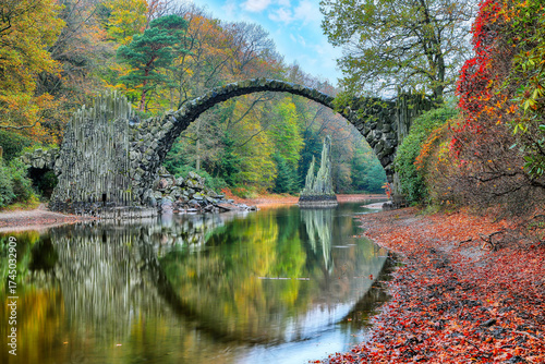 Amazing autumn landscape in Kromlau Rhododendron Park . Rakotz Bridge (Rakotzbrucke, Devil's Bridge)