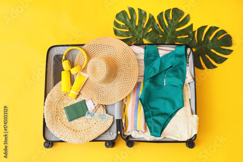 Open suitcase with clothes,...