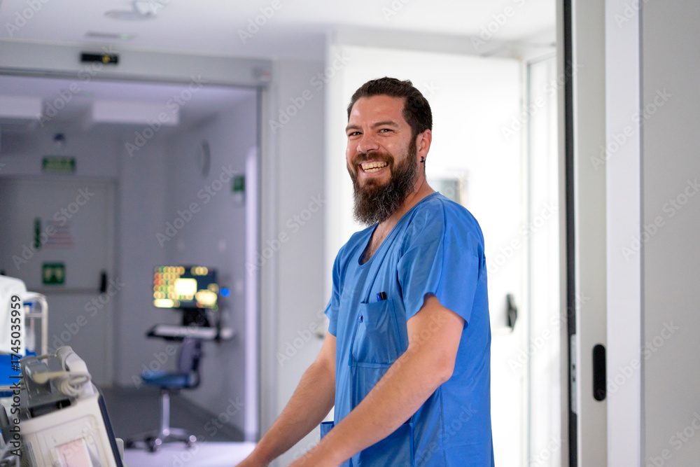 Fototapeta premium Smiling bearded healthcare professional working in hospital environment