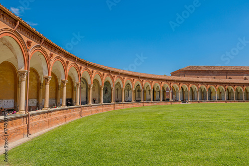 the courtyard of the monumental cemetery of Saint Christopher church, in the complex of Ferrara Charterhouse, under blue summer sky in Italy