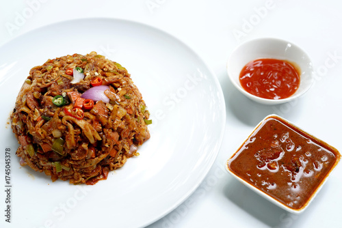Delicious Spicy Chicken Kottu Roti on White Dish.