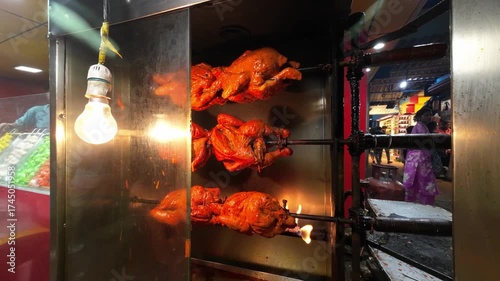 Street Food Rotisserie Chicken Roasting on Grill