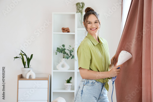 Beautiful young woman steam...