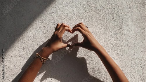 Capturing the Essence of Love: A Visual Representation of Heartfelt Emotions through Hands Forming a Heart Shape Against a Textured Background