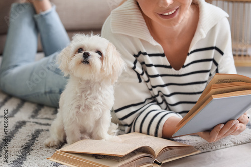 Young woman reading book wi...