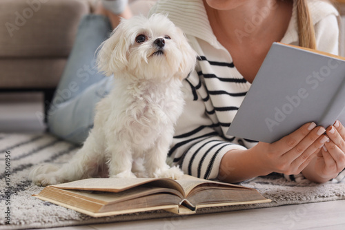 Young woman reading book wi...