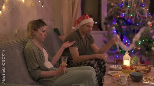 A happy married couple celebrates New Year and Christmas in a cozy apartment