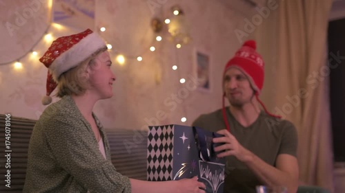 A happy married couple celebrates New Year and Christmas in a cozy apartment