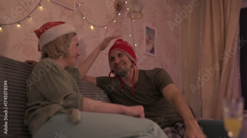 A happy married couple celebrates New Year and Christmas in a cozy apartment