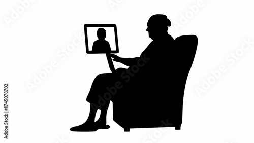 Elderly person video calling loved one on tablet while relaxing in armchair, connecting digitally