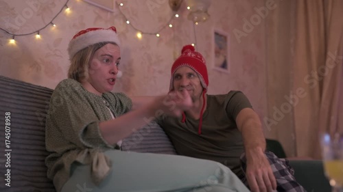 A happy married couple celebrates New Year and Christmas in a cozy apartment