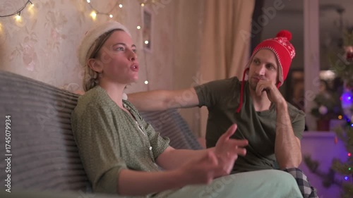 A happy married couple celebrates New Year and Christmas in a cozy apartment