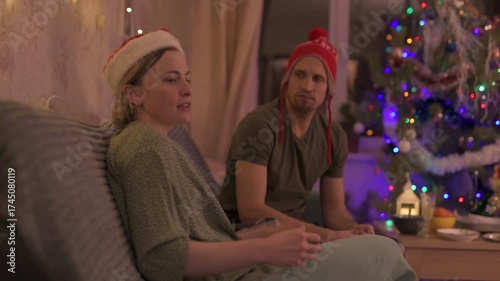 A happy married couple celebrates New Year and Christmas in a cozy apartment