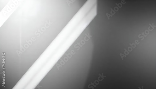 Abstract monochrome image featuring a diagonal white line against a gray background with light flare