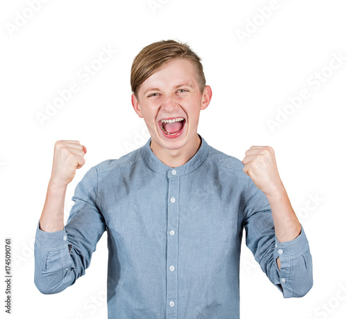 Overjoyed male teenager screaming happiness, raising up his fists, feels victorious as celebrates looking to camera. Confident and successful adolescent guy portrait isolated on transparent background