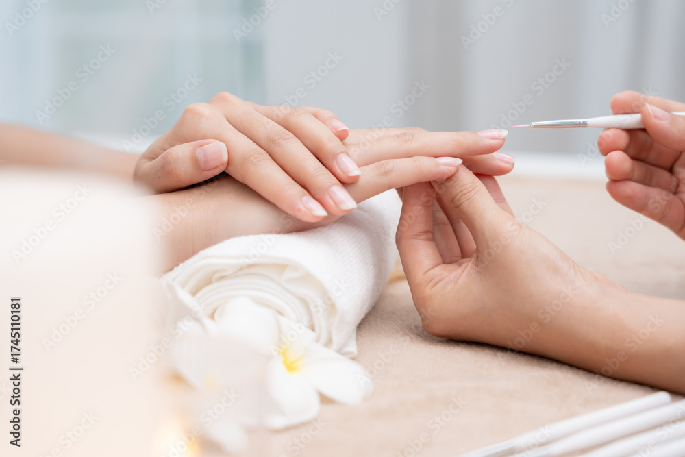 Fototapeta premium Woman receive care service by professional Beautician Manicure at spa centre. Nail beauty salon use nail file for Glazing treatment. manicurist make nail customer to beautiful. body care spa treatment