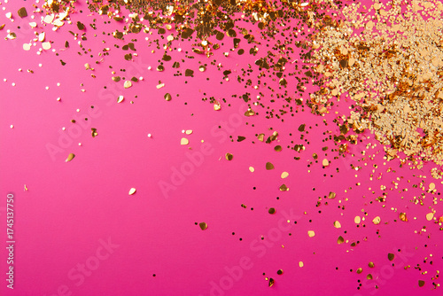 Golden confetti on a pink background.