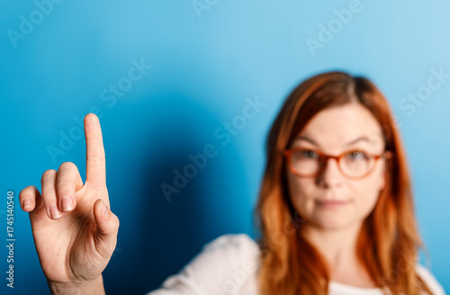 A woman with red hair and g...
