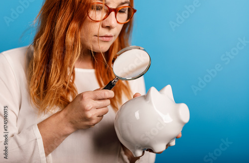 A woman with red hair and g...