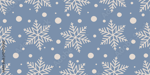 White snowflakes seamless pattern with scattered snow on blue background. Great for wrapping, greeting cards, winter fabrics, wallpapers, and digital use