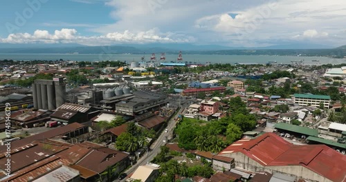 Villages and commercial buildings in City of Cagayan de Oro. Blue sky and clouds. Mindanao, Philippines.