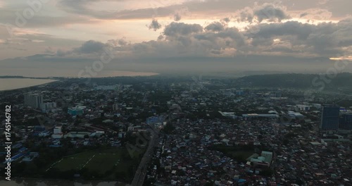 Davao City with busy streets and residential area. Mindanao, Philippines. Cityscape: City and dusk with cloudy sunset.