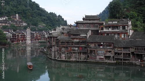 Fenghuang Ancient Town in Hunan Province, China, is a famous historic town known for its traditional Chinese architecture, stilt houses, cobblestone streets, and scenic riverside views.
